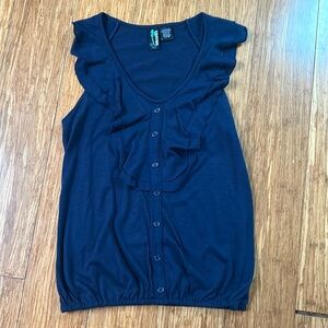 Sleeveless top, navy blue, ruffled front with buttons.